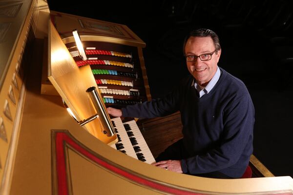 Ken Double, one of organists at the Fox Theatre poses with Mighty Mo, one of the most famous pipe organs in the country. (Tyson Horne / tyson.horne@ajc.com