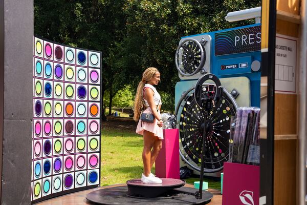 A festival attendee makes a video at the Press Play booth at the Pure Heat Community Festival in Piedmont Park on Sunday, Sept. 1, 2024. (Olivia Bowdoin for the AJC).  