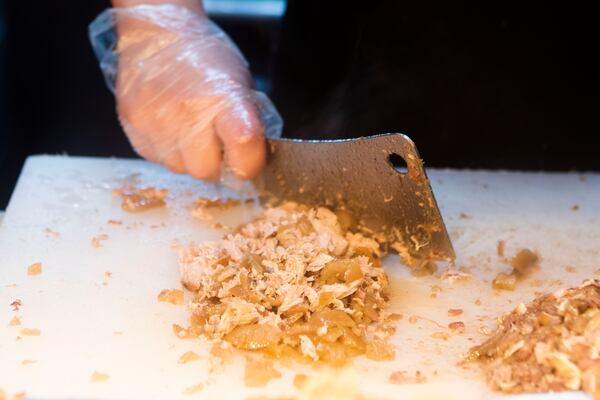 Taquero Pablo Garcia makes tacos at Carnitas Michoacan. Braised pork is the restaurant's speciality. CHRISTINA MATACOTTA FOR THE ATLANTA JOURNAL-CONSTITUTION.