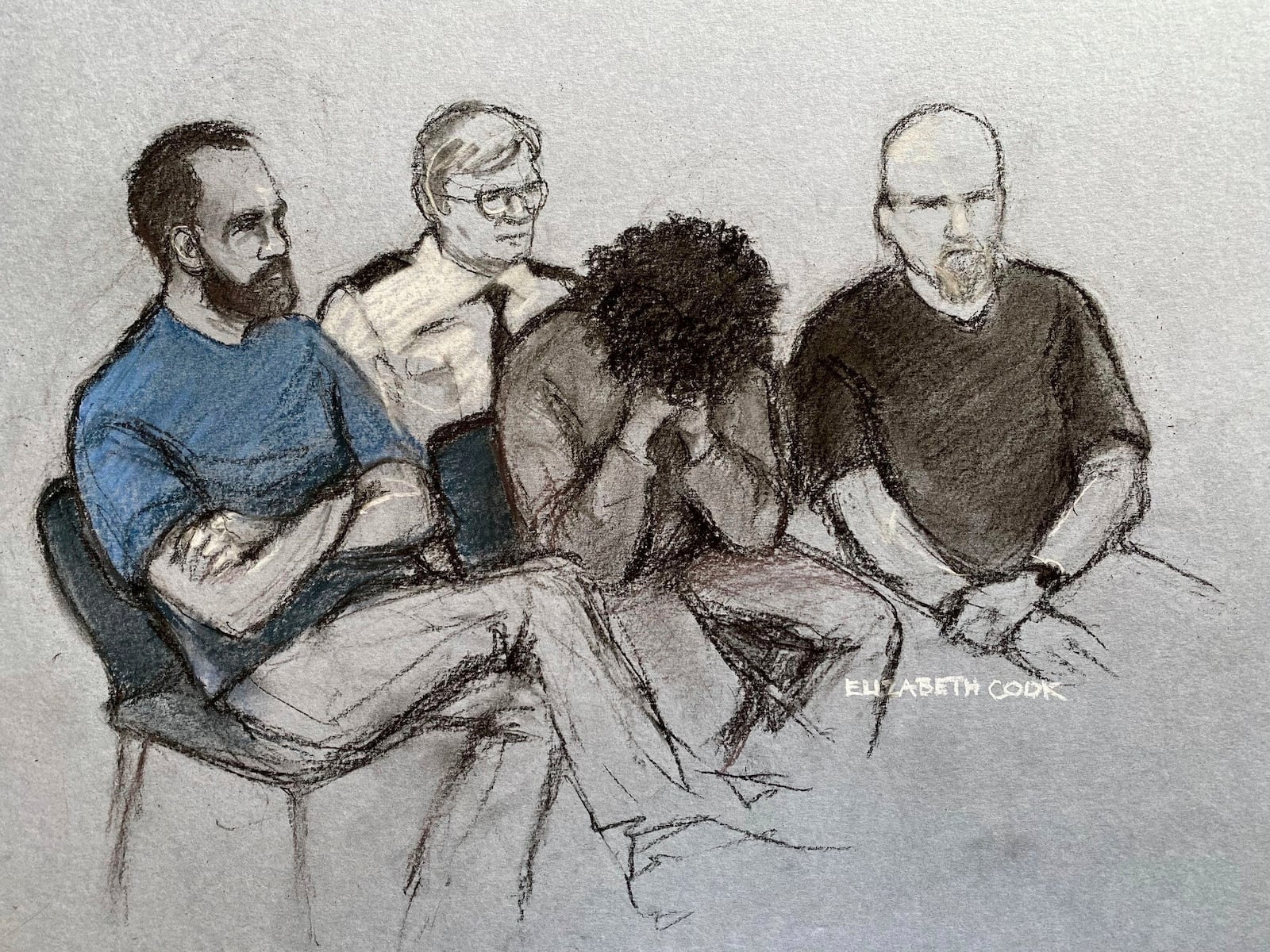 File court artist drawing by Elizabeth Cook dated Aug. 1, 2024 of Axel Rudakubana, center, covering his face as he appeared in the dock at Liverpool Crown Court, England. (Elizabeth Cook/PA via AP)