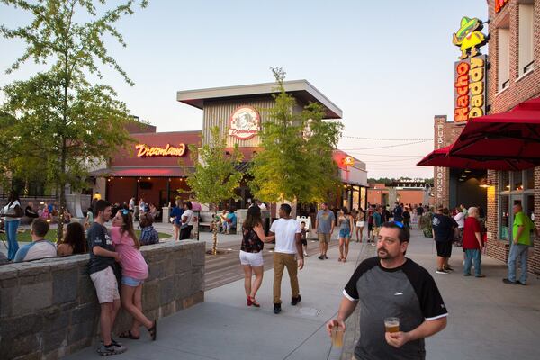 Attendees enjoy a fair-weathered evening at Parsons Alley on Food Truck Friday during the weekly summertime bash, Fridays-N-Duluth, in downtown Duluth. (Casey Sykes for the Atlanta Journal-Constitution)