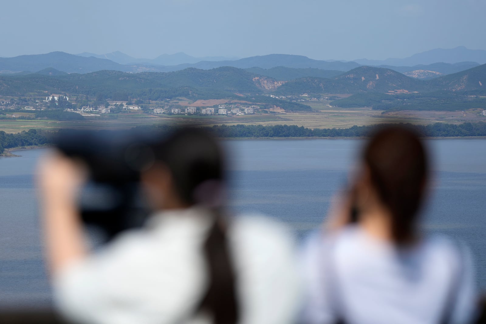 Visitors watch North Korean side from the Unification Observation Post in Paju, South Korea, Wednesday, Oct. 9, 2024. (AP Photo/Lee Jin-man)