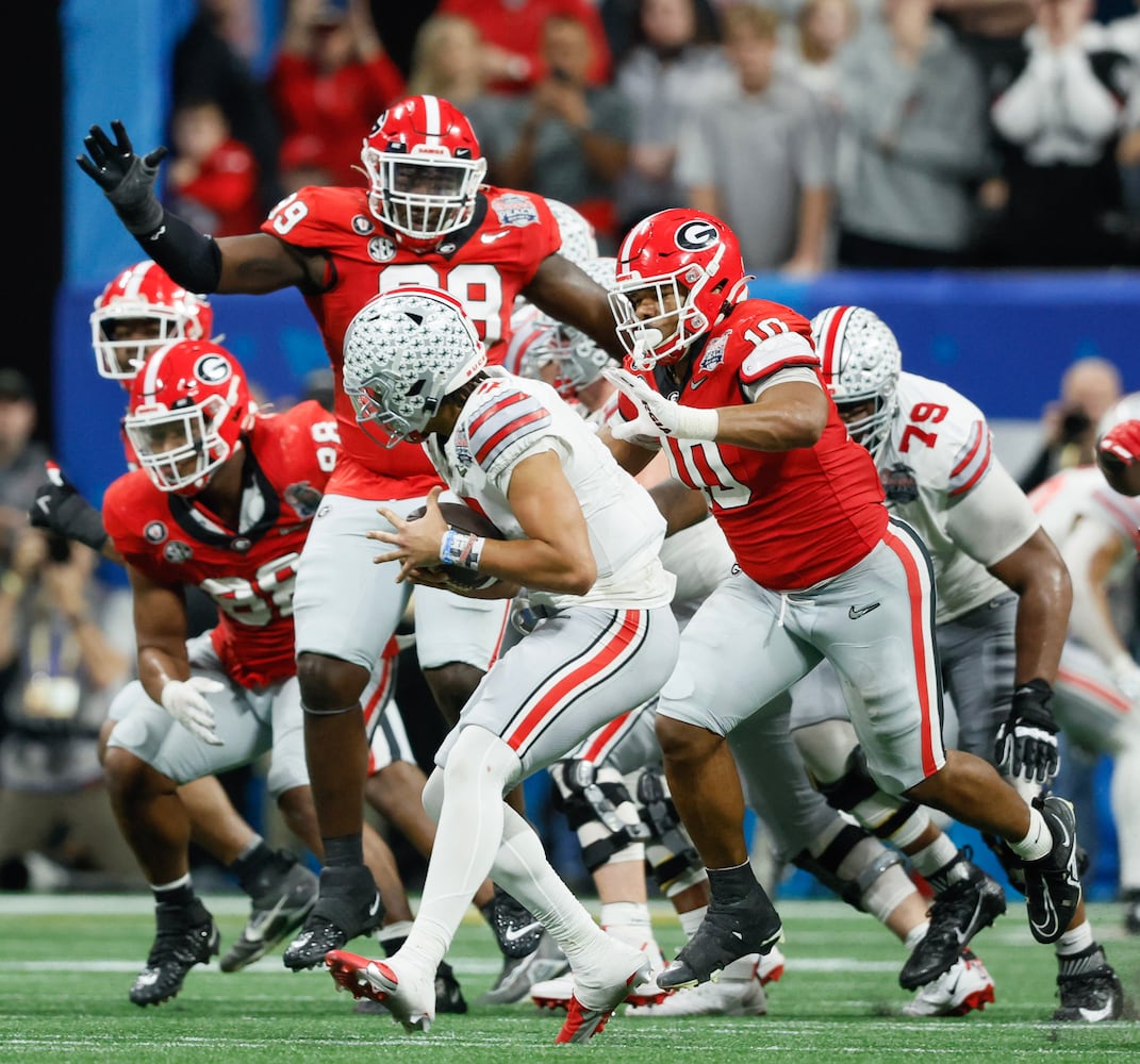 Georgia Bulldogs linebacker Jamon Dumas-Johnson (10) sacks Ohio State Buckeyes quarterback C.J. Stroud (7) with pressure from defensive lineman Bear Alexander (99) during the fourth quarter of the College Football Playoff Semifinal between the Georgia Bulldogs and the Ohio State Buckeyes at the Chick-fil-A Peach Bowl In Atlanta on Saturday, Dec. 31, 2022.  Georgia won, 42-41. (Jason Getz / Jason.Getz@ajc.com)