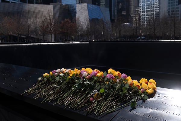 Flowers rest on names of the deceased during a ceremony marking the anniversary of the 1993 World Trade Center bombing at the 9/11 Memorial, Wednesday, Feb. 26, 2025, in New York. (AP Photo/John Minchillo)