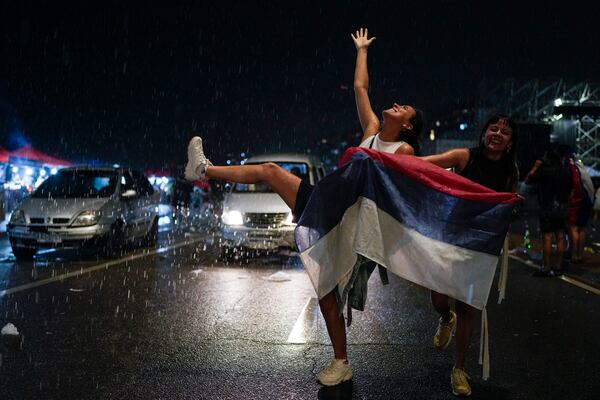 Supporters of the Broad Front (Frente Amplio) celebrate the victory of candidate Yamandú Orsi in the presidential run-off election in Montevideo, Uruguay, Sunday, Nov. 24, 2024. (AP Photo/Natacha Pisarenko)