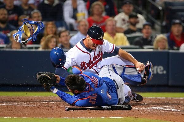 Atlanta Braves' Andrelton Simmons collides with New York Mets catcher Travis d'Arnaud at home plate in the second inning of a baseball game Friday, April 10, 2015, in Atlanta. Simmons was out on the play. (AP Photo/Kevin Liles) Shockin' the world, joltin' the Mets. (AP Photo/Kevin Liles)