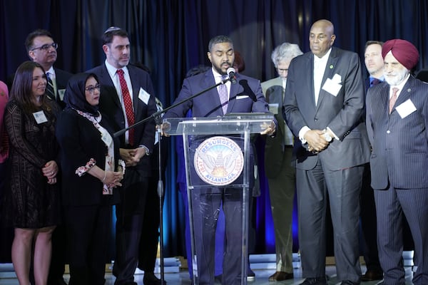 Council member Robert Hughes presented the proclamation to the diverse faith and civic leaders of the host committee.