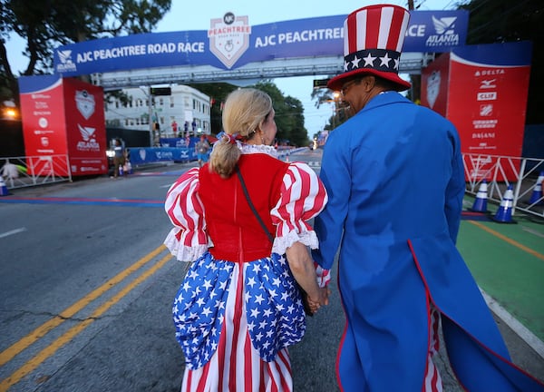 You never know who you might run into on July 4th, a day that begins in metro Atlanta with the AJC Peachtree Road Race, which Reg and Paula Barnes, dressed as Sam and Betsy Ross, previously attended. It all ends many hours later with fireworks shows in towns big and small.  CURTIS COMPTON / CCOMPTON@AJC.COM