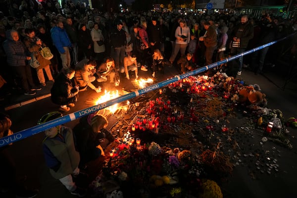 People light candles for the victims after an outdoor roof collapsed at a train station in Novi Sad, Serbia, Saturday, Nov. 2, 2024. (AP Photo/Darko Vojinovic)