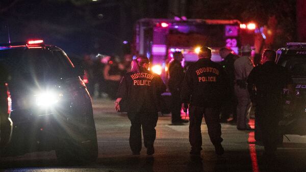 Police investigate the scene where four Houston police officers were shot in a city neighborhood on Monday, Jan. 28, 2019, during an attempted drug raid. A fifth suffered a knee injury. Two  suspects were killed during the attempted drug raid, according to  authorities.