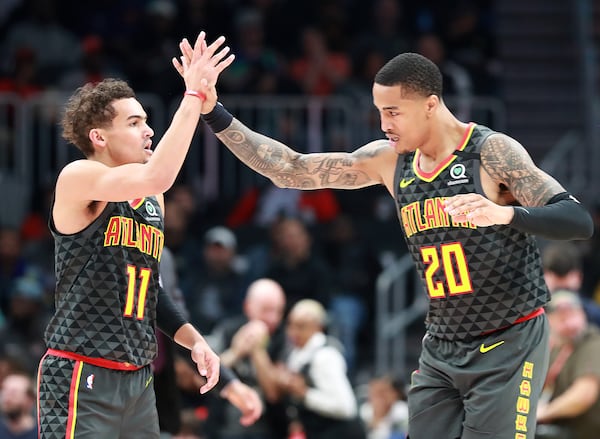 Hawks Trae Young (left) and John Collins celebrate during the 123-110 victory over the Phoenix Suns Tuesday, Jan. 14, 2020, in Atlanta. (Curtis Compton ccompton@ajc.com)