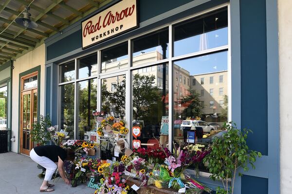 LAFAYETTE, LA - JULY 25: Mourners leave flowers at a makeshift memorial outside of a store owned by one of the two people John Russell Houser killed at a Louisiana movie theater before shooting himself.