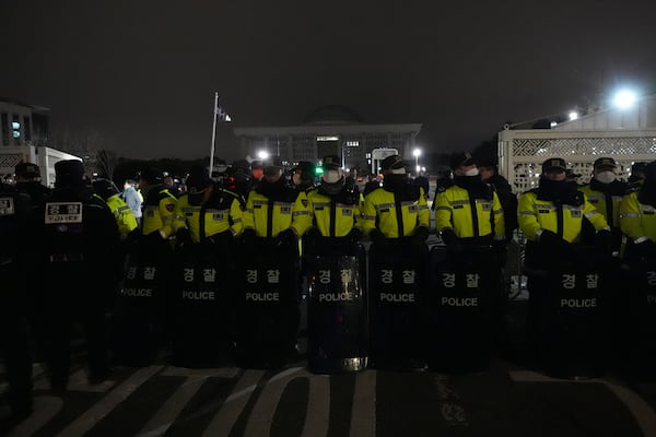 Police officers stand guard in front of the National Assembly in Seoul, South Korea, Tuesday, Dec. 3, 2024. (AP Photo/Lee Jin-man)