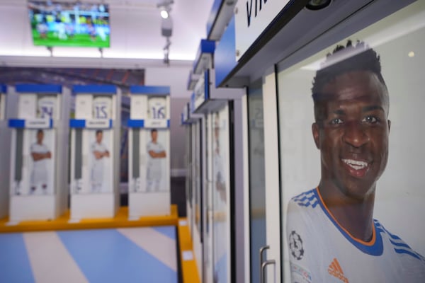 The Real Madrid first-team changing room lockers from Santiago Bernabeu Stadium are displayed at Sotheby's auction rooms in London, Wednesday, Nov. 20, 2024. The sale features 24 individual lockers previously used by footballers including Cristiano Ronaldo, David Beckham and Zinedine Zidane. (AP Photo/Kin Cheung)