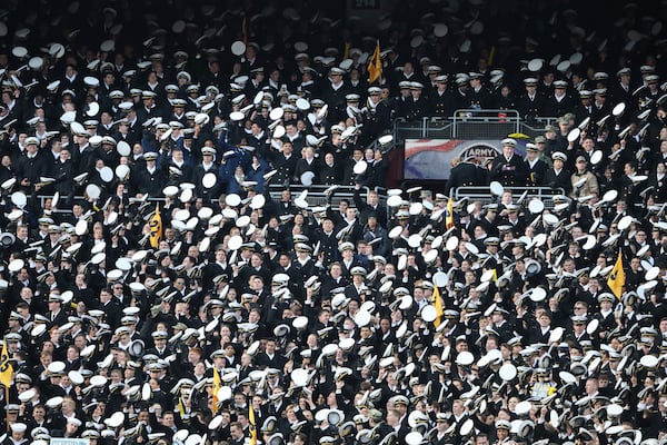 Midshipmen celebrate during the first half of an NCAA college football game against Army, Saturday, Dec. 14, 2024, in Landover, Md. (AP Photo/Daniel Kucin Jr.)