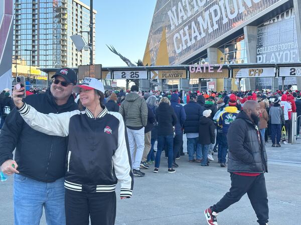 Two Ohio State fans take a selfie before their team takes on the Notre Dame Fighting Irish Monday at Mercedes-Benz Stadium in Atlanta. 