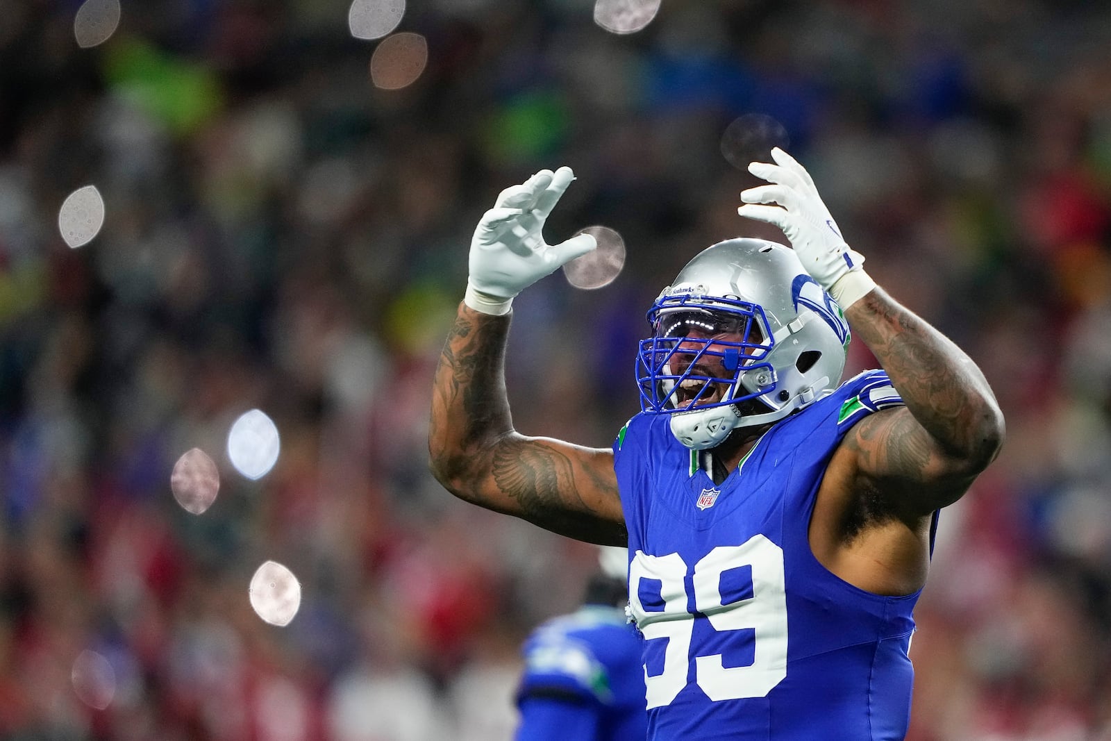 Seattle Seahawks defensive end Leonard Williams gestures to the crowd during a stoppage against the San Francisco 49ers during the second half of an NFL football game Thursday, Oct. 10, 2024 in Seattle. (AP Photo/Lindsey Wasson)