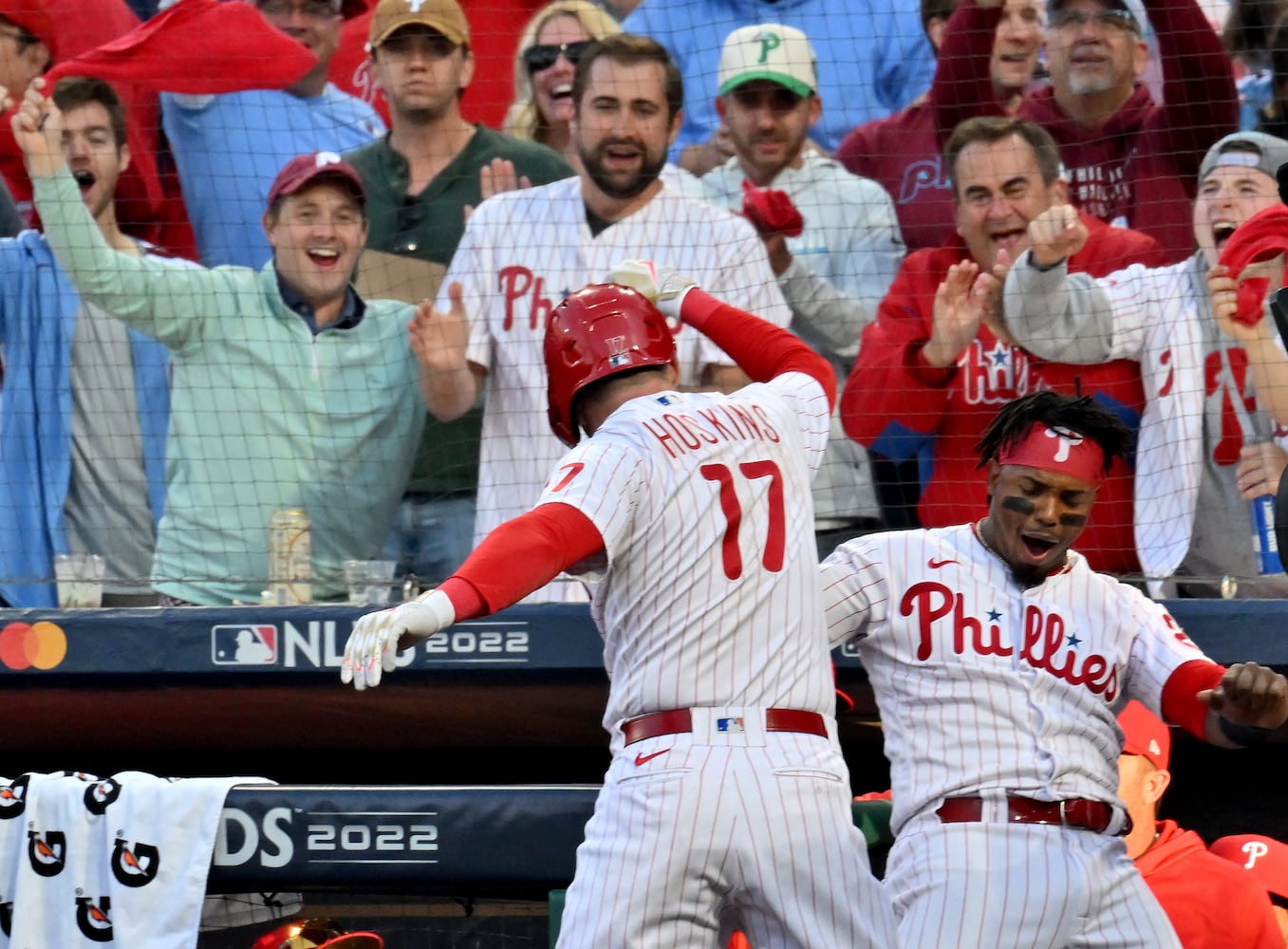 Philadelphia Phillies first baseman Rhys Hoskins (17) celebrates with Jean Segura (2) after a three-run homer against the Atlanta Braves during the third inning of game three of the National League Division Series at Citizens Bank Park in Philadelphia on Friday, October 14, 2022. (Hyosub Shin / Hyosub.Shin@ajc.com)