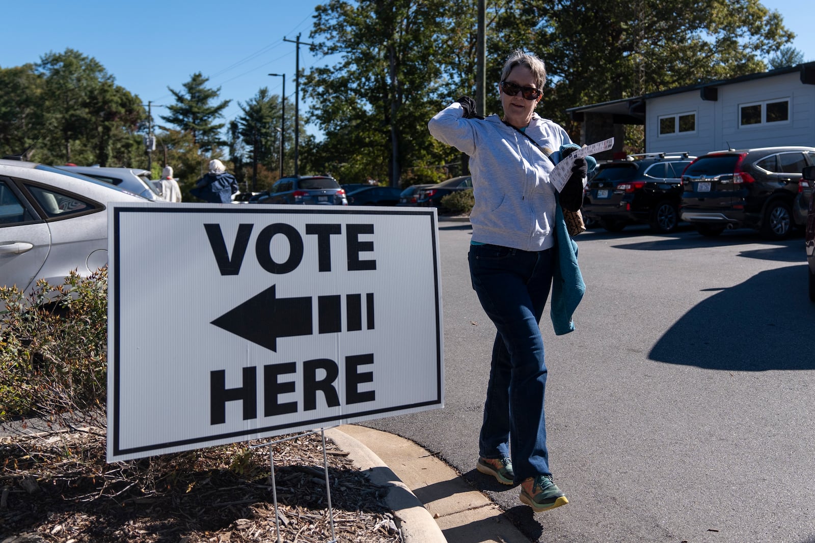 A person arrives at a polling place during the first day of early in-person voting in Asheville, N.C., Thursday, Oct. 17, 2024. (AP Photo/Stephanie Scarbrough)