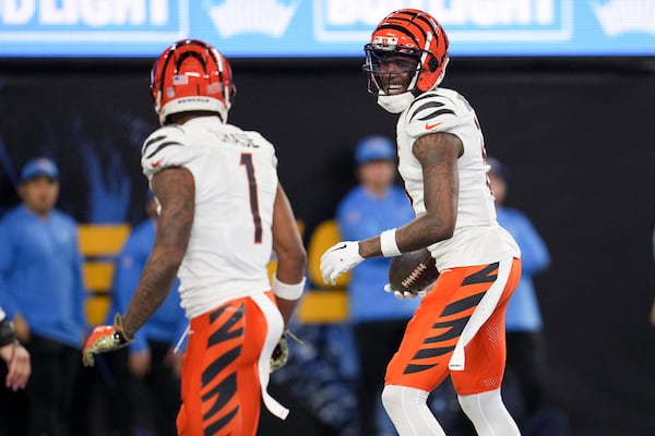 Cincinnati Bengals wide receiver Tee Higgins, right, celebrates his touchdown catch with wide receiver Ja'Marr Chase (1) during the second half of an NFL football game against the Los Angeles Chargers, Sunday, Nov. 17, 2024, in Inglewood, Calif. (AP Photo/Eric Thayer)