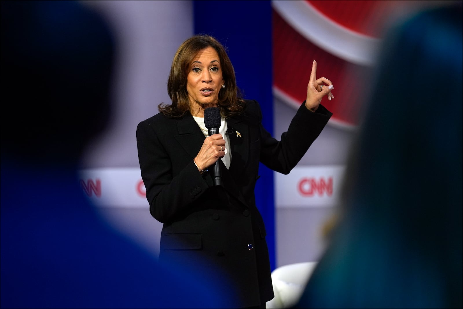 Democratic presidential nominee Vice President Kamala Harris speaks during a CNN town hall in Aston, Pa., Wednesday, Oct. 23, 2024, as moderator Anderson Cooper listens. (AP Photo/Matt Rourke)