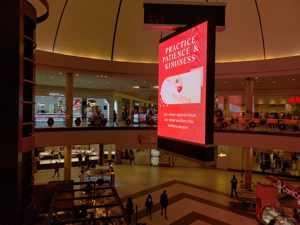 A message on a sign in Cumberland Mall's center court carries extra importance this year for stores facing a shortage of workers and delayed inventory. "Practice Patience & Kindness," the message says. "Let's show appreciation for retail workers this holiday season." MATT KEMPNER / AJC