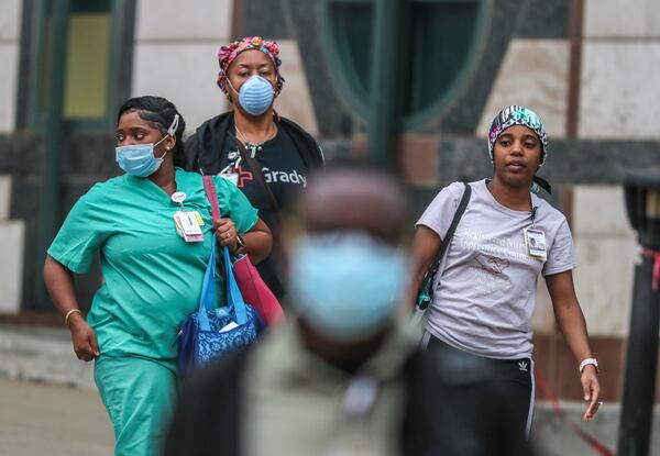 Grady Memorial Hospital medical workers leave after their shifts in downtown Atlanta on Wednesday, April 8, 2020. JOHN SPINK/JSPINK@AJC.COM