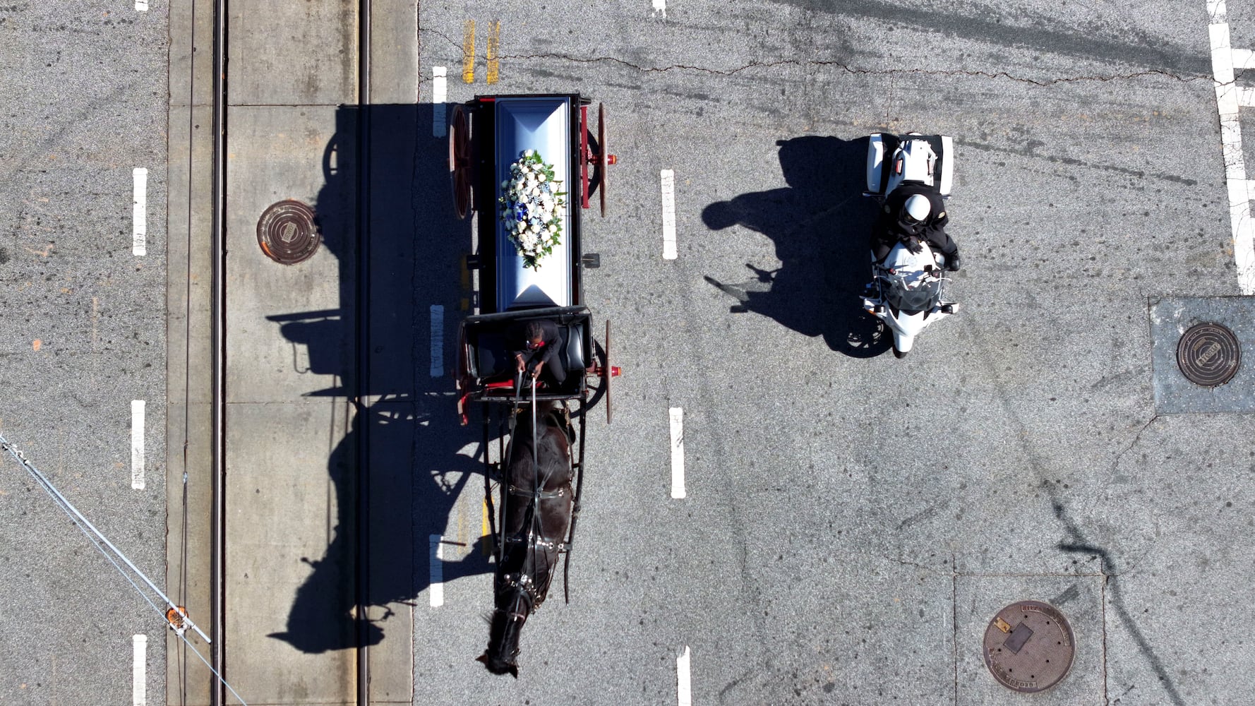 A horse-drawn carriage carrying the remains of Cornelius Taylor is being guarded by police as family and friends march to Atlanta City Hall on Monday, February 3, 2025.
(Miguel Martinez/ AJC)