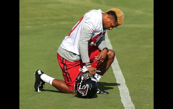 073115 FLOWERY BRANCH: Falcons rookie wide receiver Clark Marquez bows to pray before taking the field for the first day of training camp on Friday, July 31, 2015, in Flowery Branch. Curtis Compton / ccompton@ajc.com ccompton@ajc.com