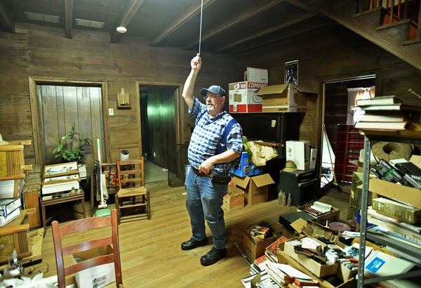 Michael Bolick, owner, shows inside Knox Cabin, a Duluth cabin that's at least 191 years old, on Wednesday, April 14, 2021. It's possibly the oldest dovetail cabin in Gwinnett County, and it could be torn down to make way for a residential subdivision. The Duluth Historical Society is trying to collect donations from the community to move it to a new location. (Hyosub Shin / Hyosub.Shin@ajc.com)