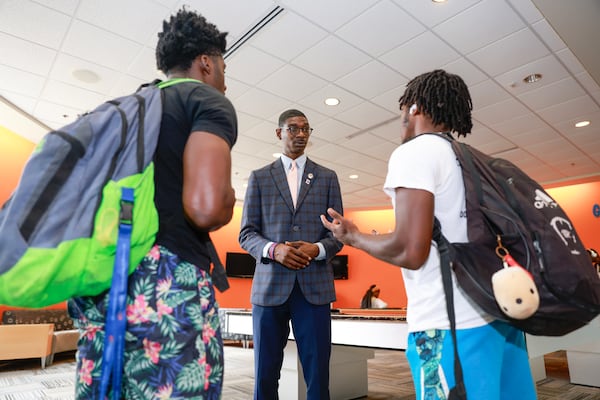 Jonesboro City Councilman Alfred Dixon (center) talks to his track and field teammates Rubin Huggins (left) and Kah’mani Zachary (right) at the Clayton State University Student Activities Center on Monday, Aug. 28, 2023. (Natrice Miller/natrice.miller@ajc.com)