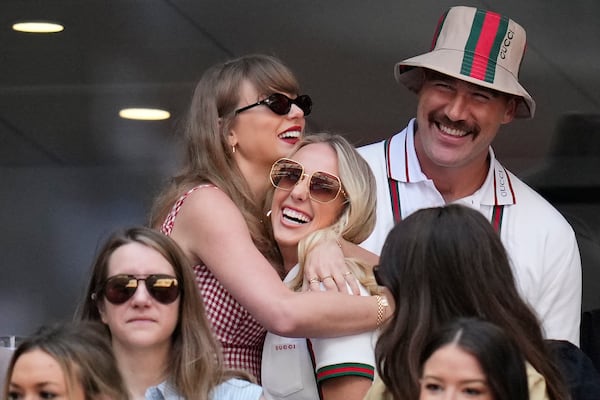 FILE - Taylor Swift, top left, hugs Brittany Mahomes as Travis Kelce, top right, looks on during the men's singles final between Jannik Sinner, of Italy, and Taylor Fritz, of the United States, at the U.S. Open tennis championships, Sept. 8, 2024, in New York. (AP Photo/Kirsty Wigglesworth, File)