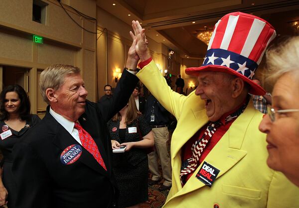 101102 Atlanta - U.S. Senator Johnny Isakson gets a high five from supporter Colonel Oscar Poole, East Ellajay, as he works the room thanking supporters upon his arrival at the Georgia Republican Party's election night event at the Grand Hyatt in Buckhead on Tuesday, Nov. 2, 2010.   Curtis Compton ccompton@ajc.com