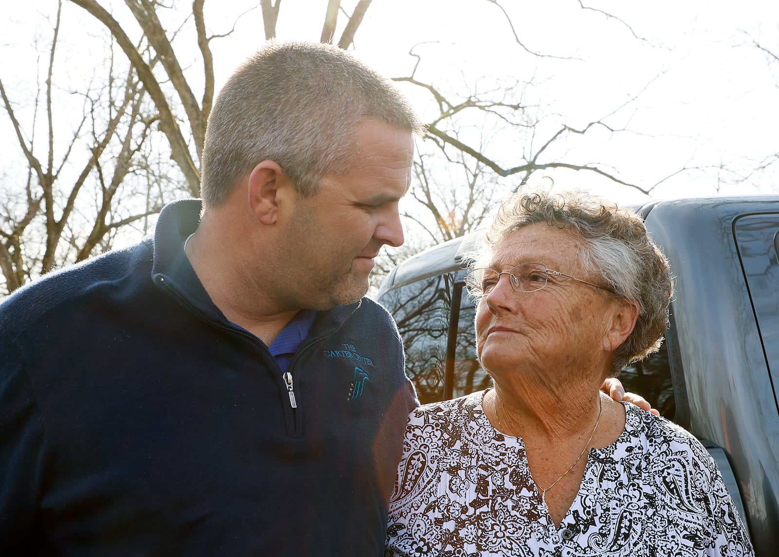 Zac Steele (left) and Jan Williams (right) share a moment as they talked to media before Sunday service at Maranatha Baptist Church. Neighbors, friends and church members of former President Jimmy Carter gathered at the church in Plains, Sunday, February 19, where Carter long taught Sunday school lessons until his health declined. The former U.S. president and Georgia governor, 98 years old, is in hospice at home in Plains, Georgia. (Ryon Horne / Ryon.Horne@ajc.com)