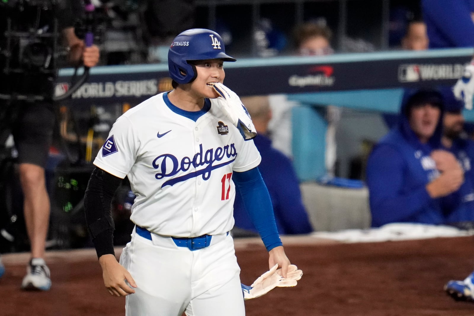 Los Angeles Dodgers' Shohei Ohtani reacts after scoring during the eighth inning in Game 1 of the baseball World Series against the New York Yankees, Friday, Oct. 25, 2024, in Los Angeles. (AP Photo/Julio Cortez)