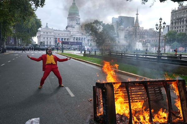 A protester in a Joker costume takes part in a demonstration by soccer fans and retirees demanding higher pensions and opposing austerity measures implemented by Javier Milei's government in Buenos Aires, Argentina, Wednesday, March 12, 2025. (AP Photo/Rodrigo Abd)