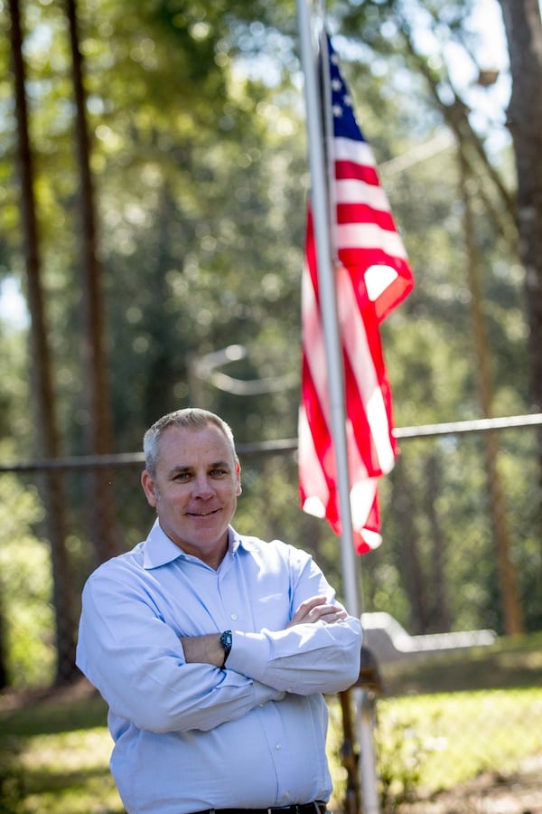 Tyler Bowser, who served in the Air Force in the late 1990s and again from January 2008 through 2011, stands in front of the American flag at the Veterans Empowerment Organization facility. Bowser says his work for the VEO “is the most rewarding job I’ve ever had.” STEVE SCHAEFER / SPECIAL TO THE AJC