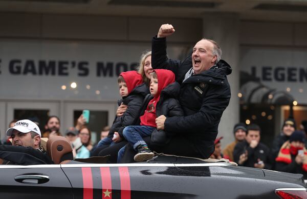 December 10, 2018 - Atlanta, Ga: Atlanta United President Darren Eales celebrates with fans as he rides with his family during the Atlanta United MLS Cup victory parade along Marietta Street Monday, December 10, 2018, in Atlanta.  (JASON GETZ/SPECIAL TO THE AJC)