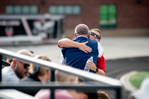 Two men share a hug. Hundreds gather at Flowery Branch High School  to celebrate the life of Ricky Aspinwall II. Sunday, Sept. 8, 2024 (Ben Hendren for the Atlanta Journal-Constitution)