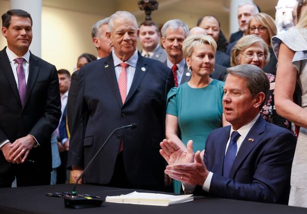 With much fanfare, Gov. Brian Kemp signs HB 1013, which aims to increase access to mental health coverage in Georgia on Sine Die, the last day of the General Assembly at the Georgia State Capitol in Atlanta on Monday, April 4, 2022.   (Bob Andres / robert.andres@ajc.com)