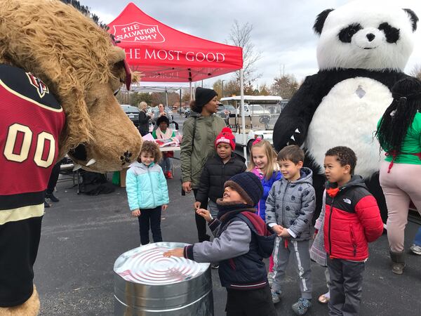 The Atlanta Gladiators  mascot plays drums with some local kids at the 11Alive Canathon November 30, 2019. That's the Illuminate Panda bear in the background. CREDIT: Rodney Ho/rho@ajc.com