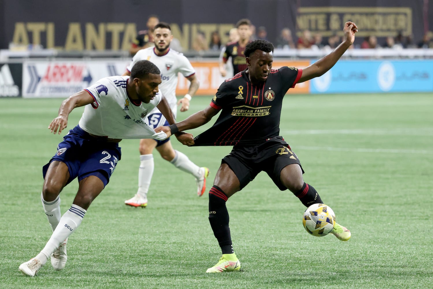 D.C. United defender Donovan Pines (23, left) fouls Atlanta United defender George Bellow (21) during the first half at Mercedes-Benz Stadium Saturday, September 18, 2021 in Atlanta, Ga.. JASON GETZ FOR THE ATLANTA JOURNAL-CONSTITUTION