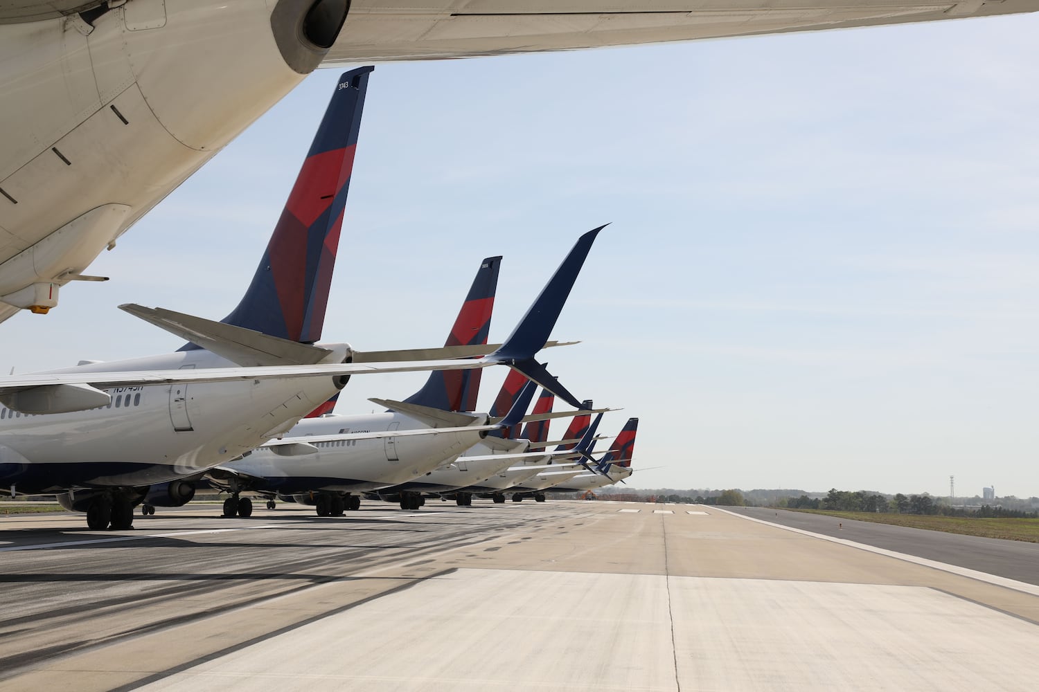 Flight cuts: Delta planes parked on Atlanta airport runway, taxiways