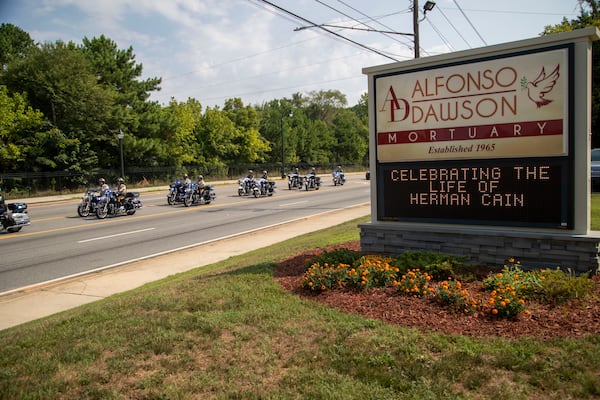 08/07/2020 - Marietta, Georgia - A police motorcade escorts the family go Herman Cain to Alfonso Dawson Mortuary before the start of his funeral service in Atlanta's Harland terrace community, Friday, August 7, 2020. Cain, former Republican presidential candidate, businessman and radio broadcaster, died July 30 at the age of 74. The Henry County resident had been hospitalized for a month with COVID-19 after traveling throughout much of June, including to a rally for his ally President Donald Trump. (ALYSSA POINTER / ALYSSA.POINTER@AJC.COM)