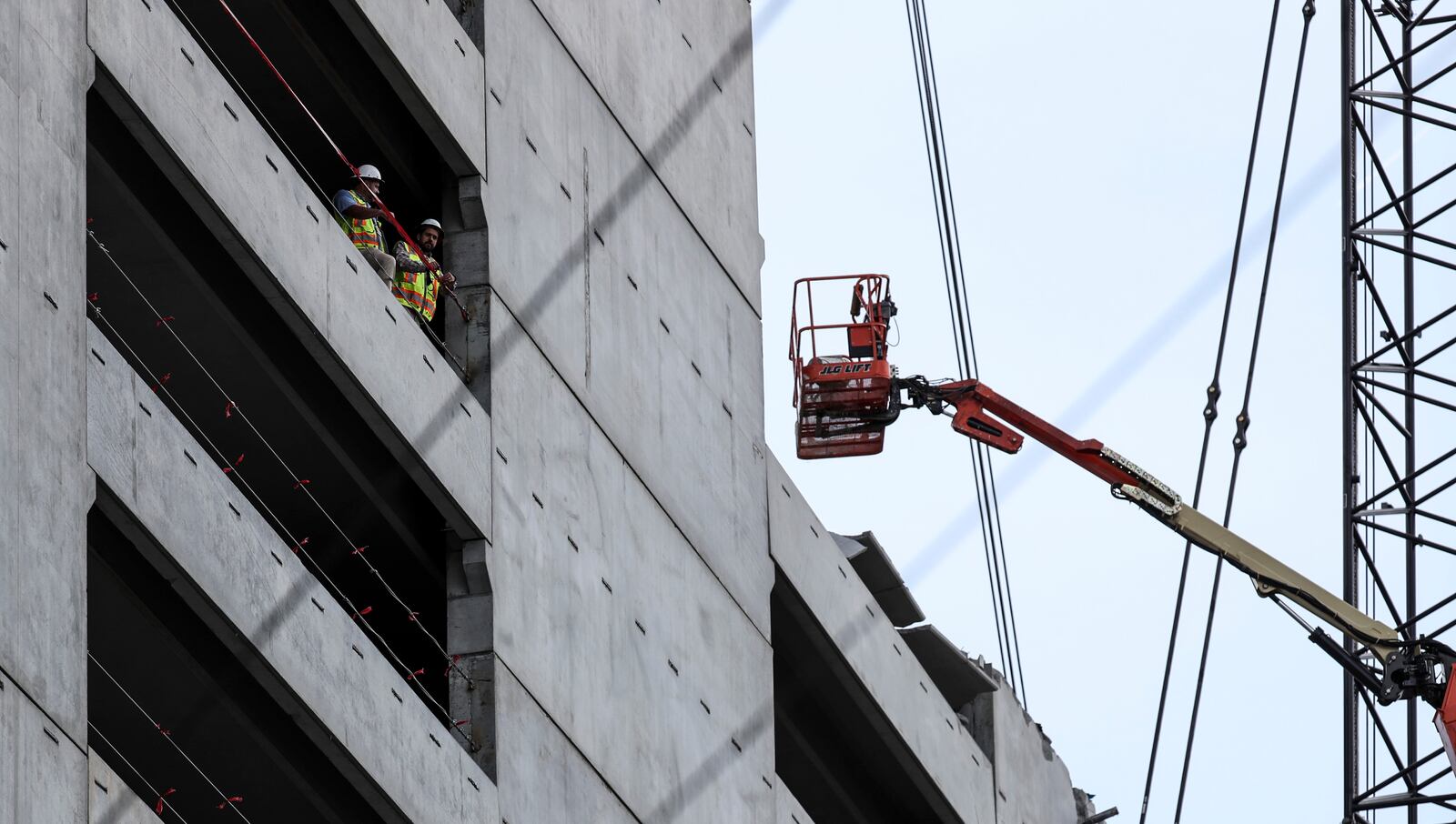 One worker was placed on a stretcher and lowered to the ground with a crane after crews lifted him out of the rubble.