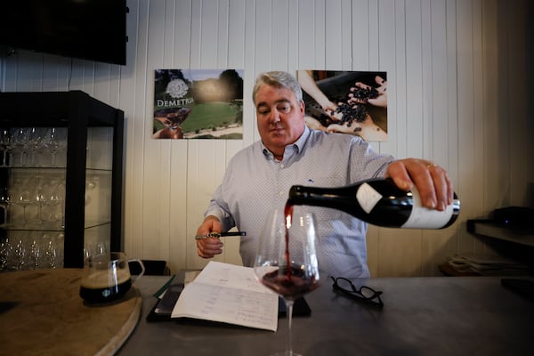 Michael Tomlin, owner of Clover Wine Merchant shop located on Carroll Street in downtown Perry, Georgia, pours a glass of wine on Thursday, February 13, 2025. The area features diverse businesses and shops, reflecting ongoing developments in this historic downtown location.
(Miguel Martinez/ AJC)