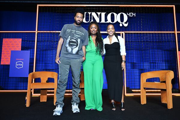 Cam Kirk (from left), Tenika B and Zeny Shifferaw pose on stage at UNLOQ404, An Inaugural Creators Summit In Atlanta presented by UTA at Overtime Elite Arena on October 14, 2023 in Atlanta. (Photo by Derek White/Getty Images for UTA)