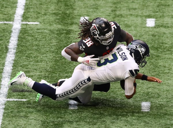 091320 Atlanta: Atlanta Falcons defensive end Takk McKinley sacks Seattle Seahawks quarterback Russell Wilson on his first offensive play during the first quarter Sunday, Sept. 13, 2020 in Atlanta.  (Curtis Compton / Curtis.Compton@ajc.com)