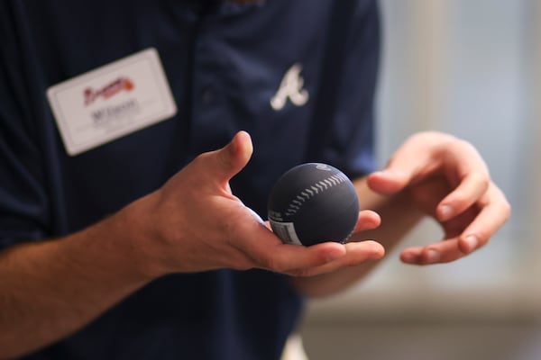 Tossing balls to guests is one of Wilson's duties as a greeter for Braves games. (Jason Getz / AJC)

