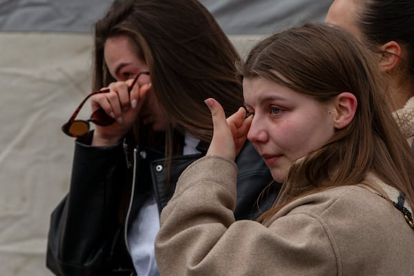 Women cry and wait in line to write condolence messages for the victims of a massive nightclub fire in the town of Kocani, North Macedonia, Monday, March 17, 2025. (AP Photo/Visar Kryeziu)